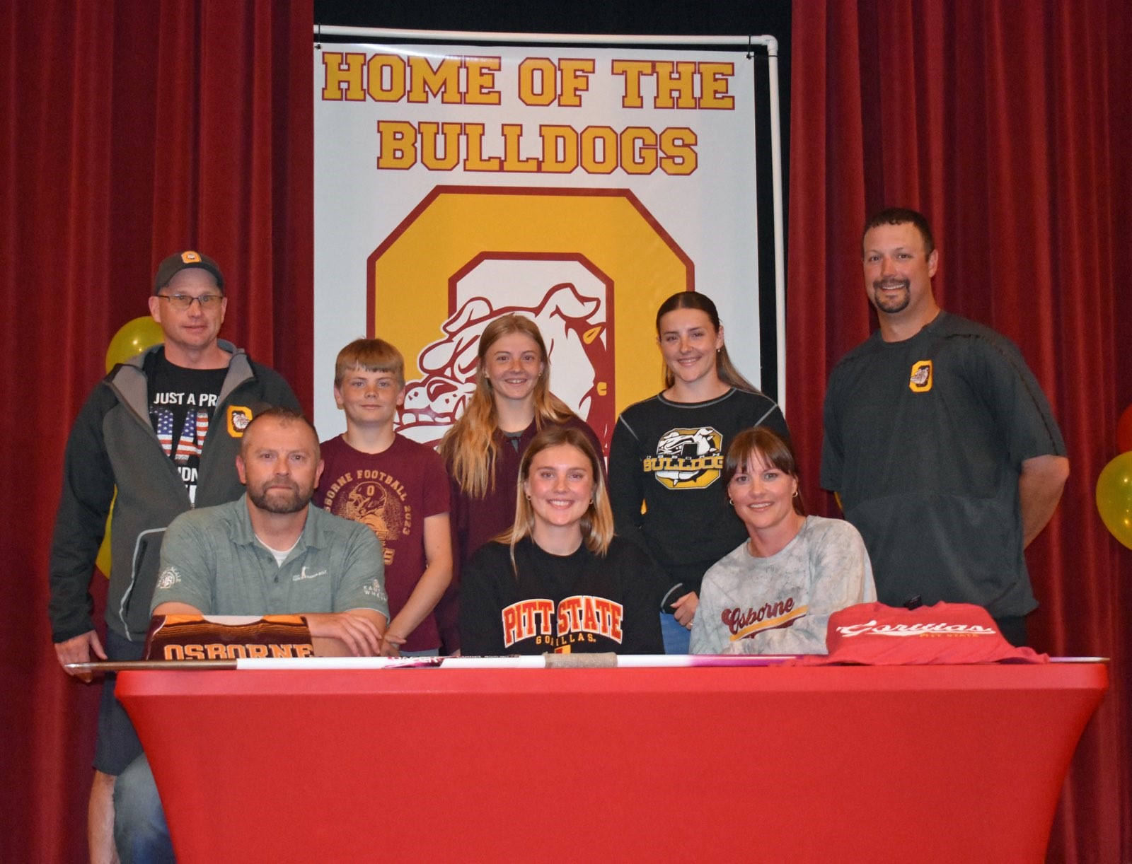 Front row (L to R): Dad Cullen Riner, Gracie Riner, Mom Angie Riner; Back row (L to R): Osborne T&F coach Steve Tiernan, Riner's siblings, Osborne AD Anthony Blair (Photo by Stephanie Baxa)